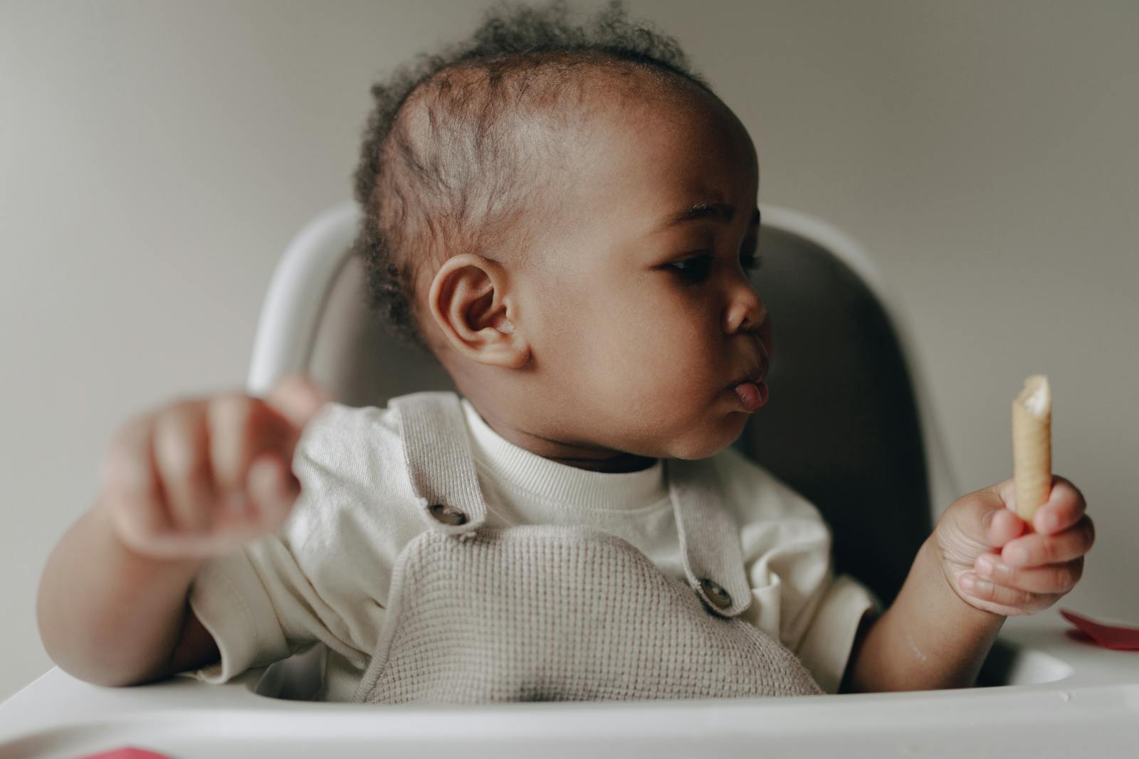 Parent qui propose une cuillère de purée maison à bébé pour la diversification alimentaire